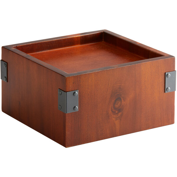 A walnut wood square riser with metal corners.