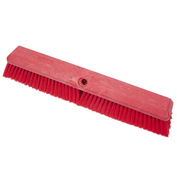 A red Carlisle Sparta Omni Sweep brush head with bristles.