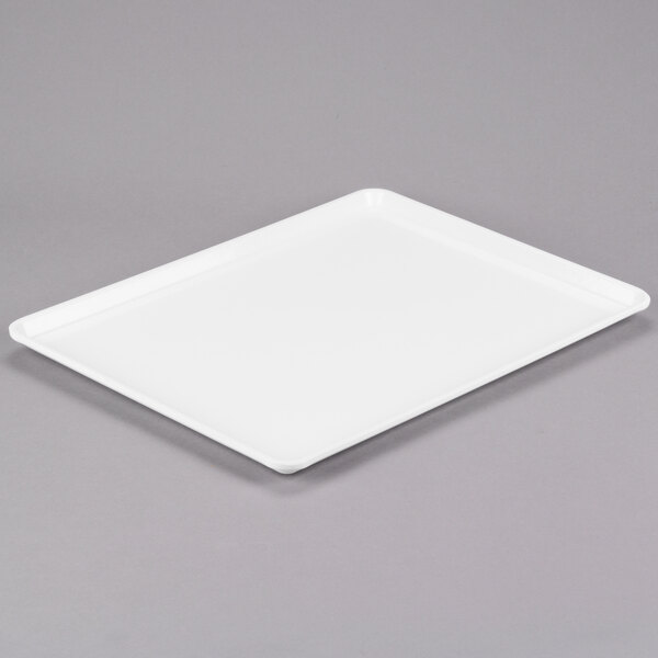 A white rectangular Cambro dietary tray on a gray surface.