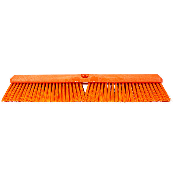 A close up of a Carlisle orange push broom head with long bristles.