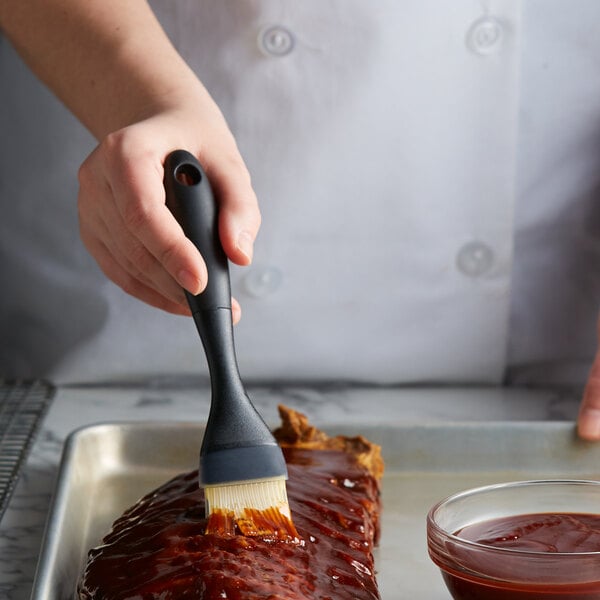 a person holding a black spatula