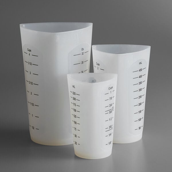 A Tablecraft 3-piece flexible silicone measuring cup set with three different sizes.