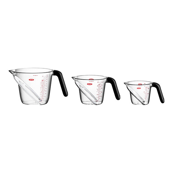 A group of clear OXO Good Grips angled measuring cups with handles.