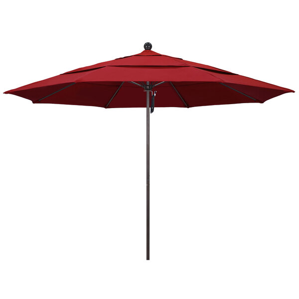A close-up of a red California Umbrella on a bronze pole.