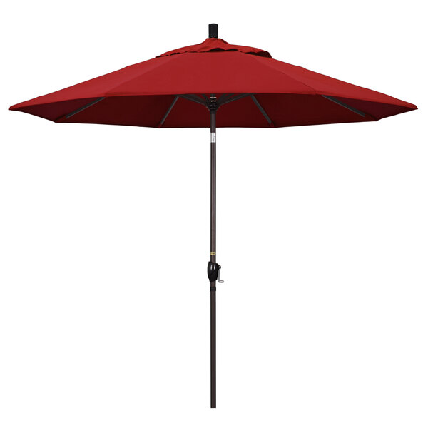 A close-up of a red California Umbrella on a bronze pole.