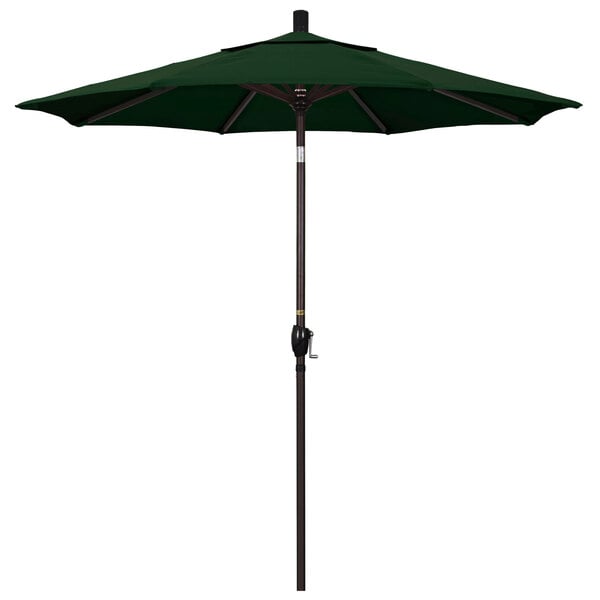 A green California Umbrella on a bronze pole.