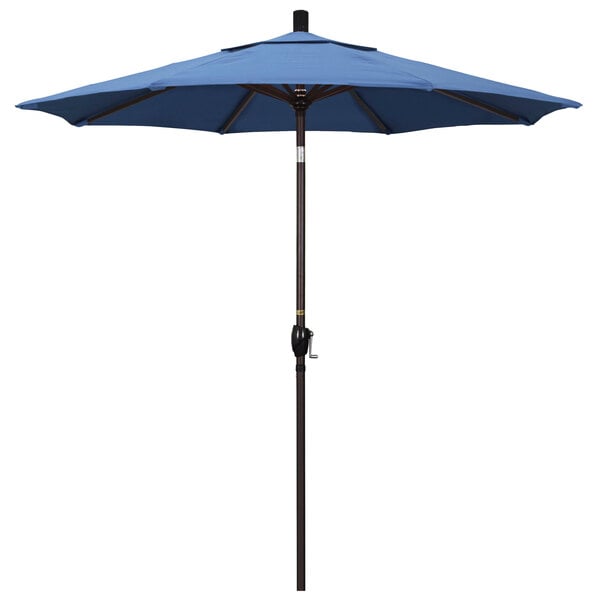 A blue California Umbrella on a bronze pole.