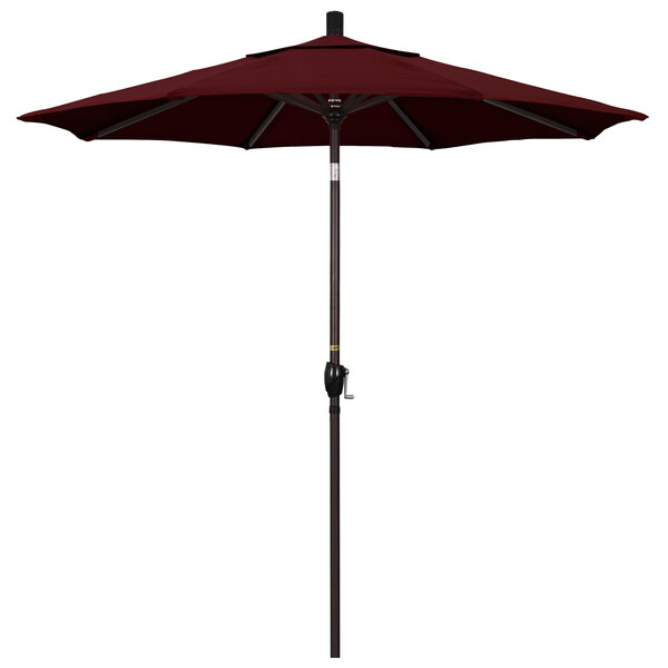 A close-up of a burgundy California Umbrella with a bronze pole.