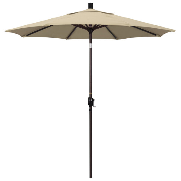 A beige California Umbrella on a bronze aluminum pole.