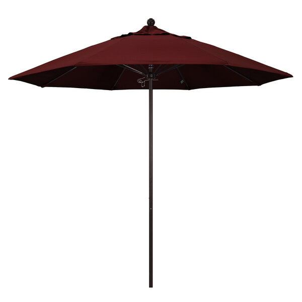 A red California Umbrella with a bronze pole.