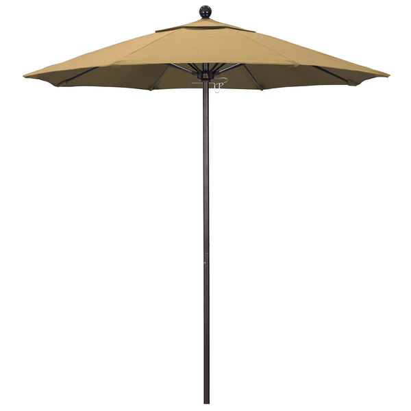 A champagne colored California Umbrella with a bronze pole.
