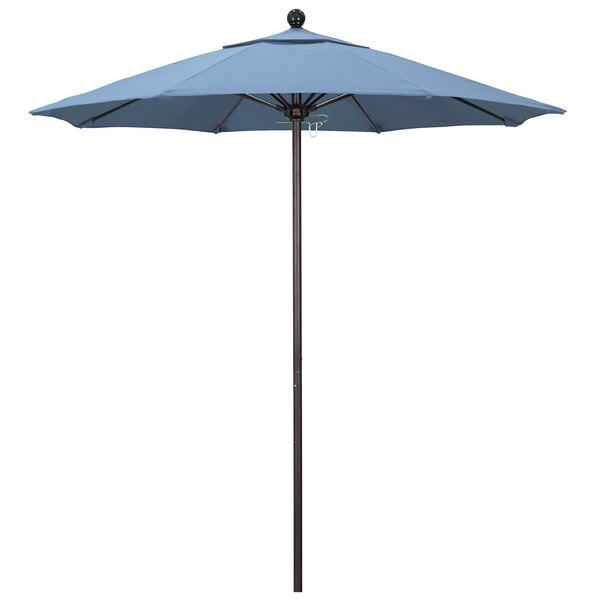 A California Umbrella ALTO Sunbrella round umbrella in air blue on a bronze pole.