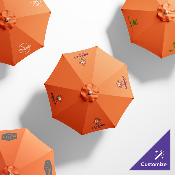 A customizable California Umbrella with a silver pole and orange Sunbrella fabric with a Tuscan pattern.