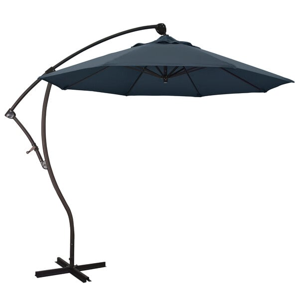 A large blue California Umbrella with a metal stand.