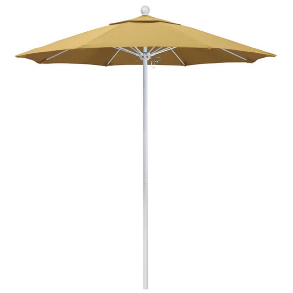 A close-up of a yellow California Umbrella with Sunbrella wheat fabric canopy on a white pole.