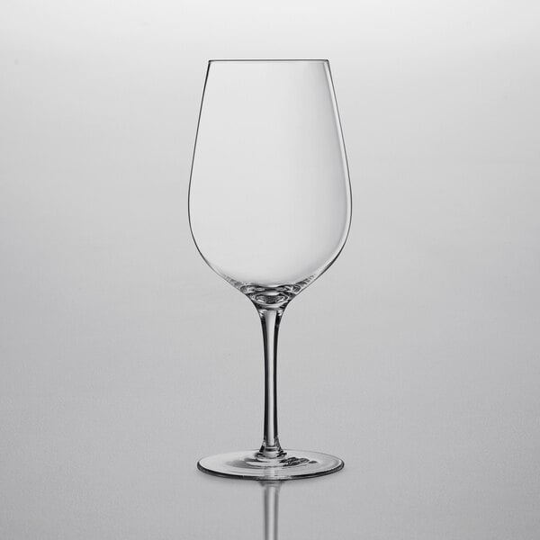 A clear Chef & Sommelier Bordeaux wine glass on a white surface.