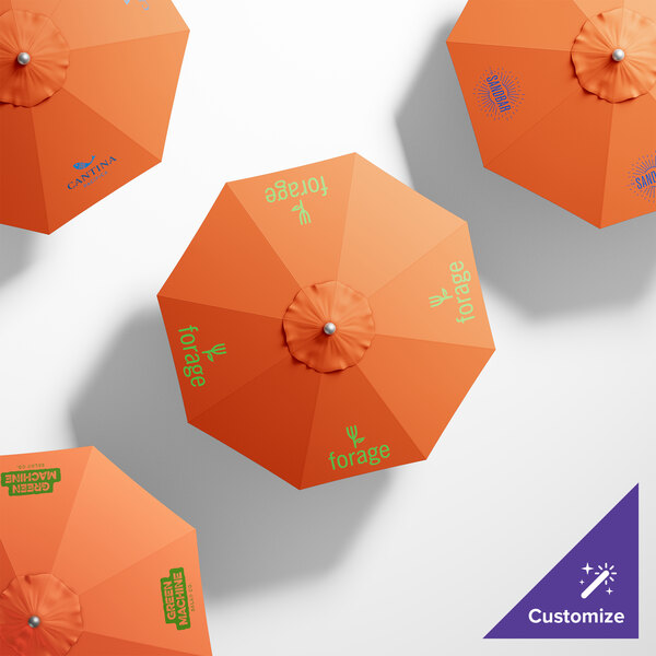 A white California Umbrella with a Sunbrella Tuscan canopy and green text on it.