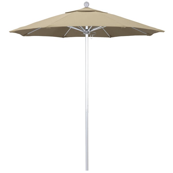 A beige California Umbrella on a silver metal pole.
