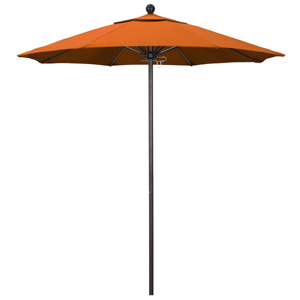 An orange California Umbrella on a black pole.