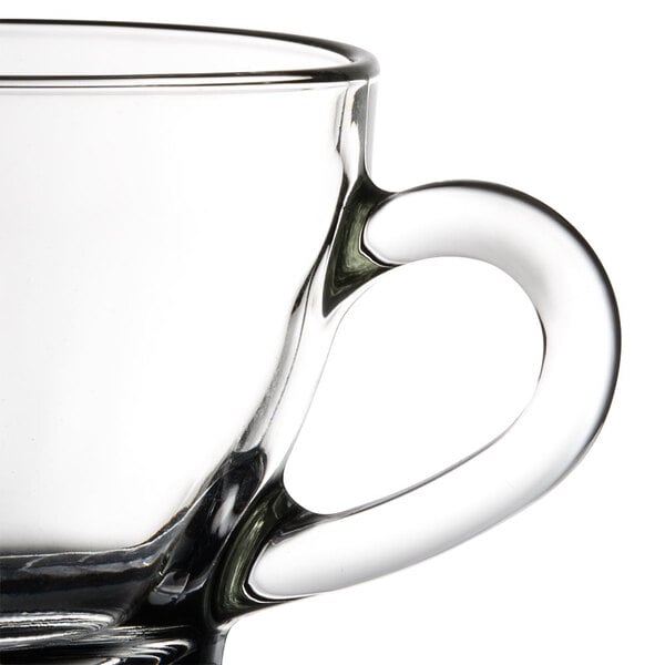 A Libbey clear glass cappuccino cup with a handle.
