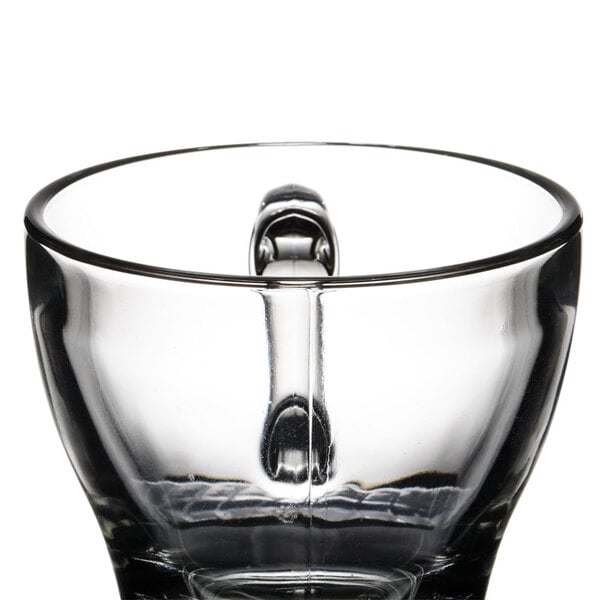 A Libbey clear glass cappuccino cup with a handle.