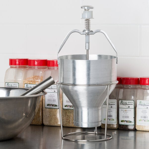 An aluminum batter dispenser with a stand.