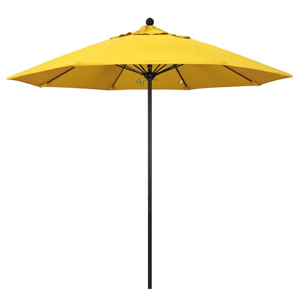 A yellow California Umbrella on a black pole.