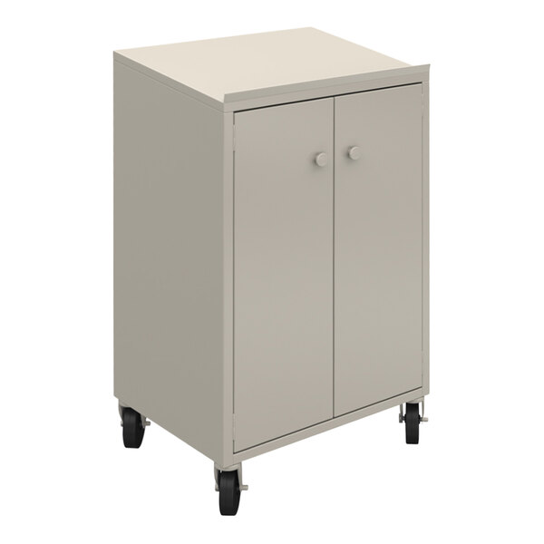 A beige steel shop desk with lockable doors on wheels.