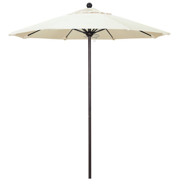 A white California Umbrella on a bronze pole.
