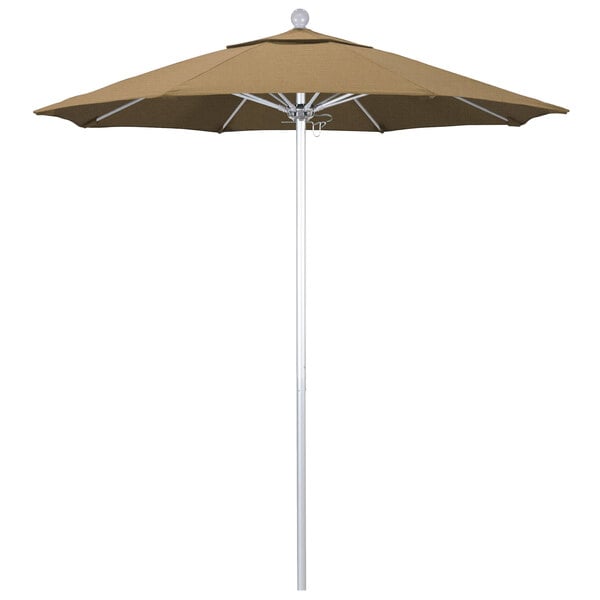 A California Umbrella straw-colored round outdoor umbrella with a silver pole.