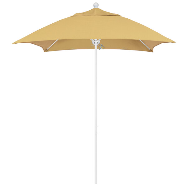 A tan California Umbrella with a yellow Sunbrella canopy on a white pole.