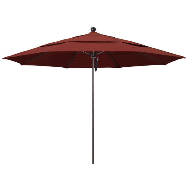A red California Umbrella on a bronze pole.