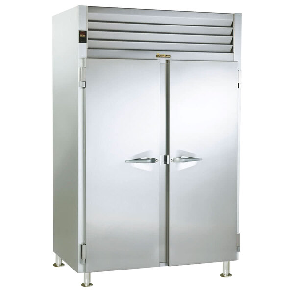 A Traulsen two section stainless steel reach-in refrigerator with white doors open.