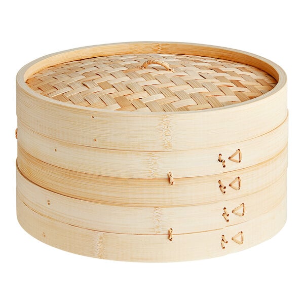 A Town bamboo steamer set on a table with a lid.