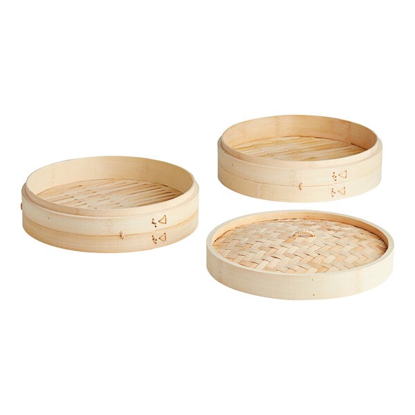 A Town bamboo steamer set with round wooden containers and lids.
