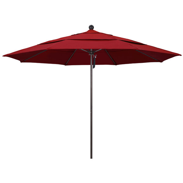 A red California Umbrella on a bronze pole.