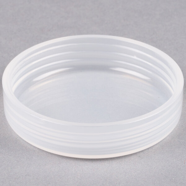 A white plastic container with a circular lid.