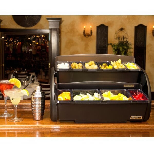 A San Jamar two tier condiment bar on a counter.