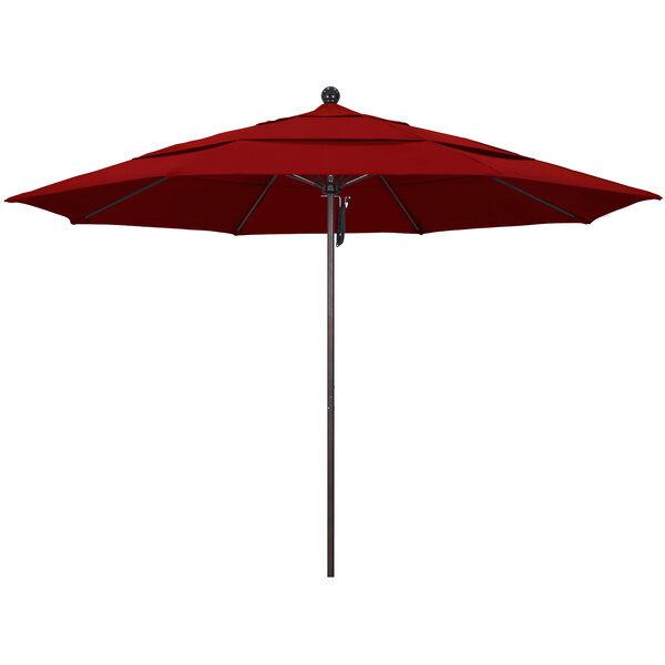 A red California Umbrella on a bronze pole.