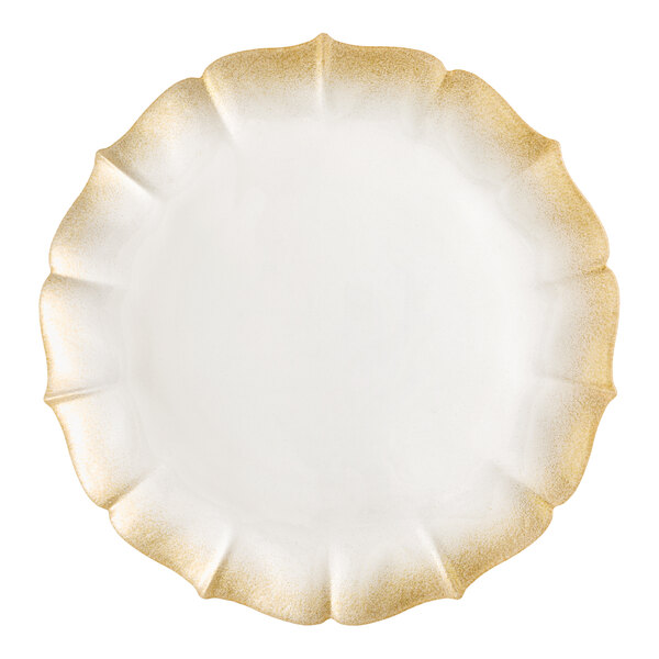 A round glass charger plate with a scalloped edge and a gold pearl finish.