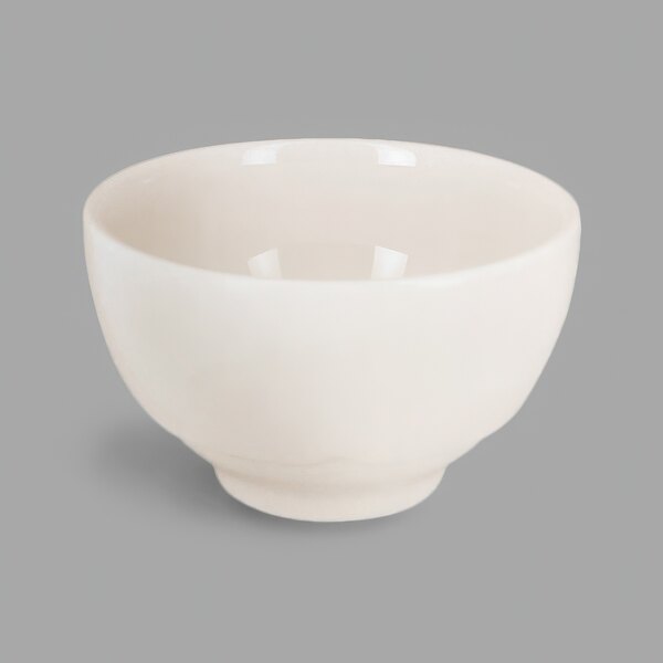 A RAK Porcelain ivory china bowl with a handle.