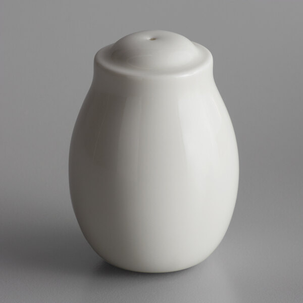 A white porcelain pepper shaker with a hole in the top.