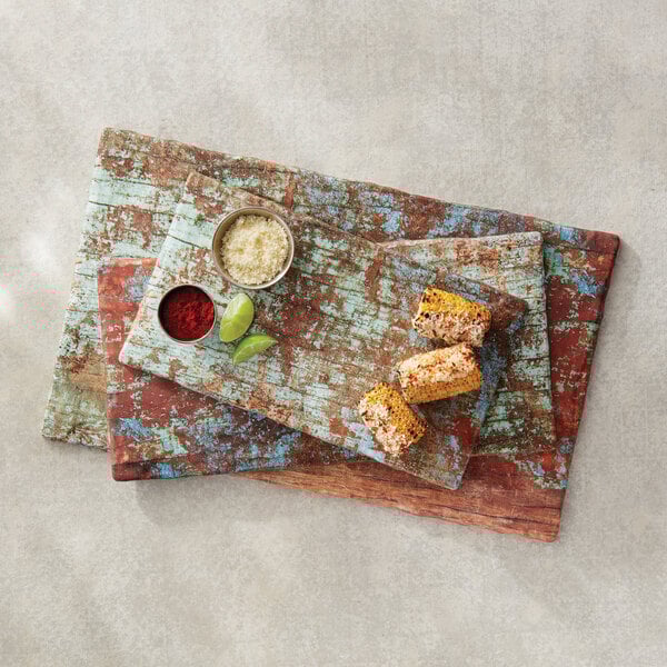 An American Metalcraft faux reclaimed wood melamine rectangular serving board with food on it.