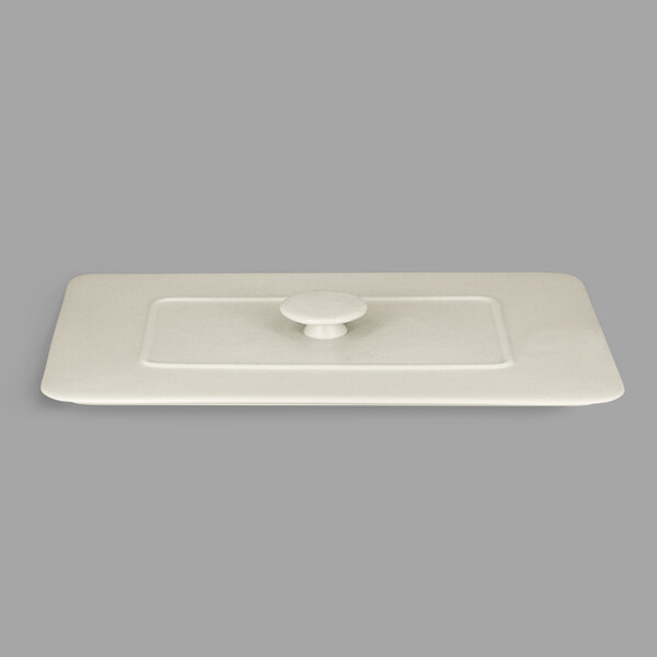 A white rectangular porcelain tureen lid with a handle.