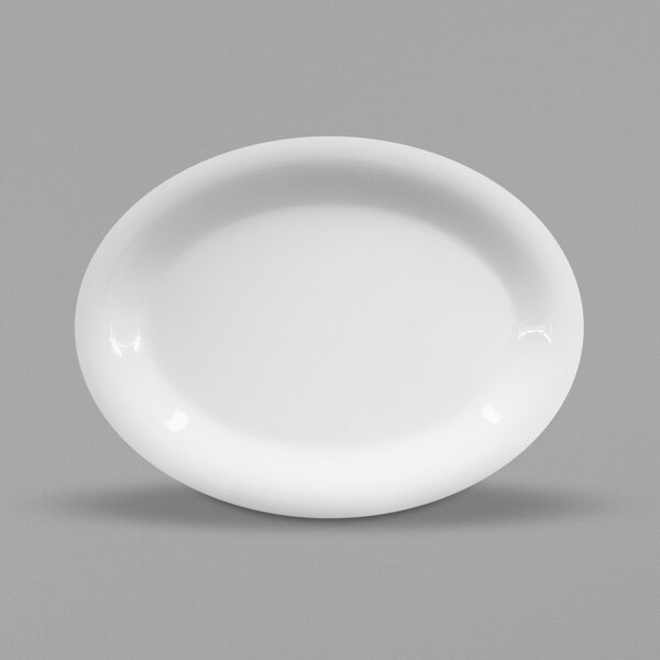 A white oval Elite Global Solutions melamine platter on a gray surface.