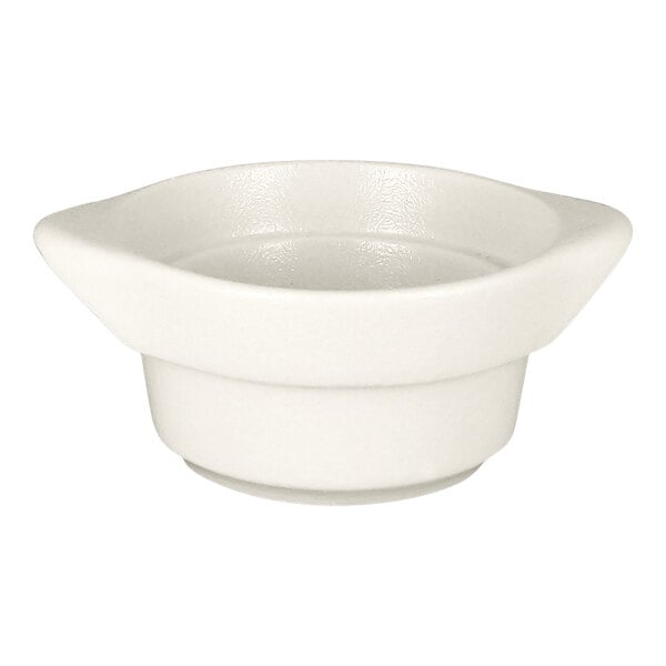 A round sand white porcelain cocotte with a wide rim and 7.3 oz. capacity.