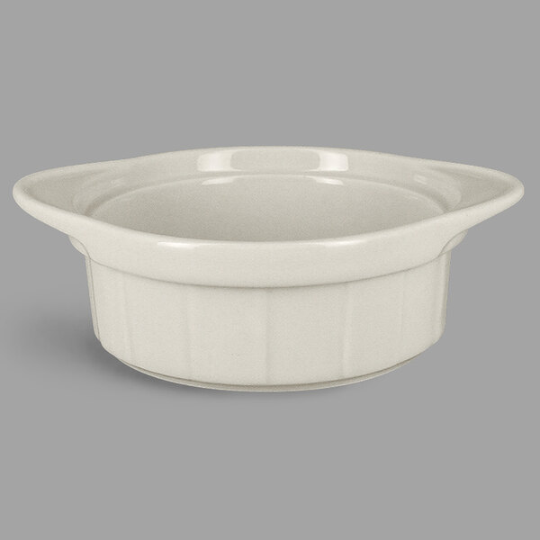 A close up of a RAK Porcelain sand white porcelain ramekin with grooves.