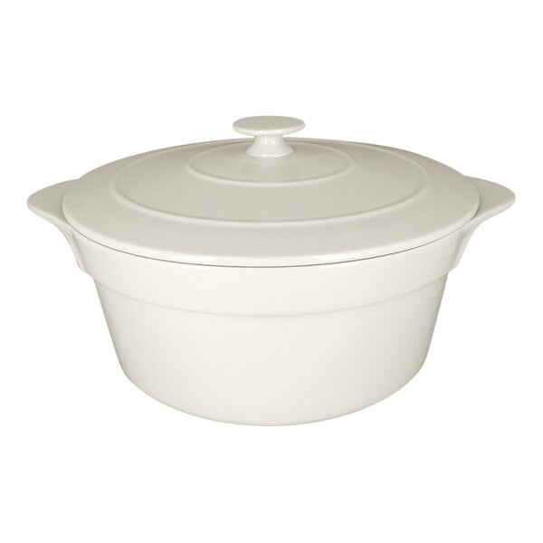 A large round sand white porcelain cocotte with a lid and side handles.