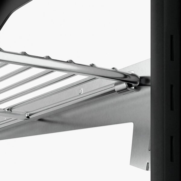 A close-up view of a metal shelf inside a refrigerated countertop bakery display case.