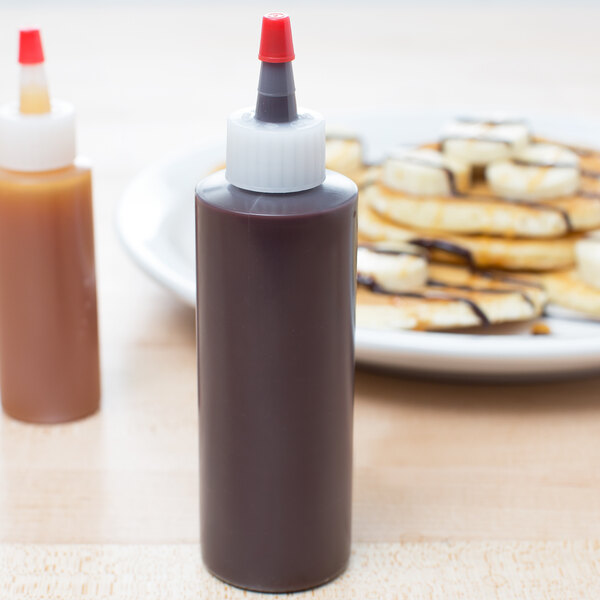 A 4 oz. chef squeeze bottle with a red-tipped nozzle and white cap, used for dispensing sauces or condiments.